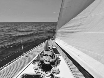 Portrait of man on boat in sea against sky