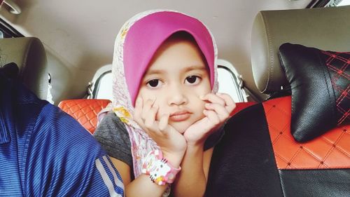 Portrait of cute girl sitting in bus