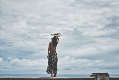 Silhouette of man standing against cloudy sky