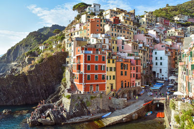 Buildings by sea against sky in city