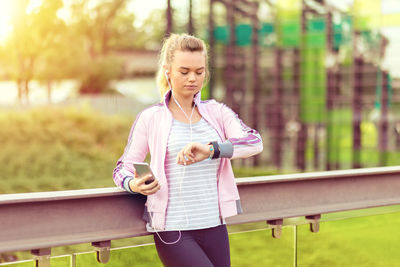 Young woman using smart phone outdoors