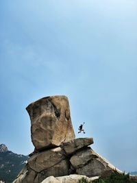 Low angle view of rock formations against sky