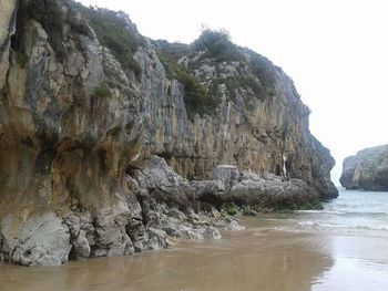 Scenic view of rocks in sea against sky