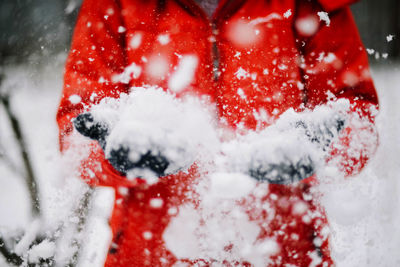 A young woman playing in the snow