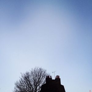 Low angle view of built structure against clear blue sky