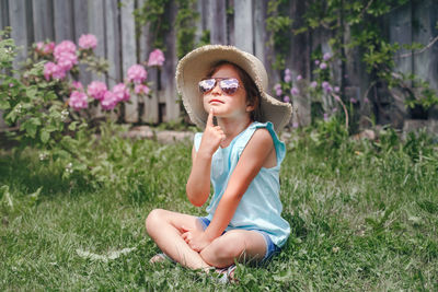 Portrait of cute boy sitting on grass