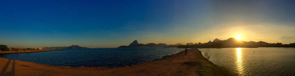 Scenic view of sea against blue sky during sunset