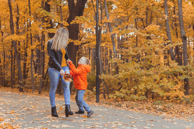 Full length of man standing by trees during autumn