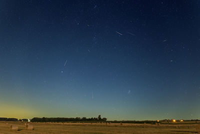 Scenic view of field against sky at night