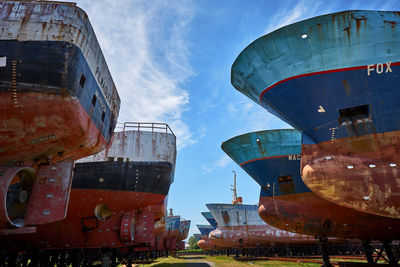 Low angle view of abandoned ship against sky