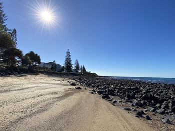 Scenic view of sea against clear sky on sunny day