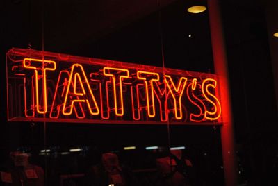 Information sign on illuminated restaurant at night