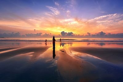 Scenic view of beach against sky during sunset