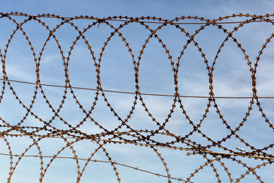 Low angle view of chainlink fence against clear sky