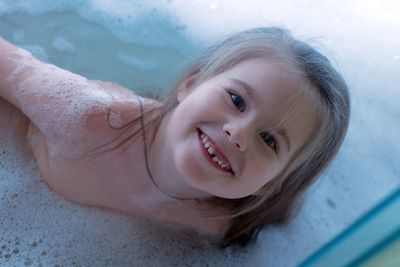 High angle view of young woman swimming in lake