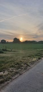 Scenic view of field against sky during sunset