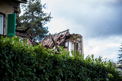 Low angle view of abandoned building against sky