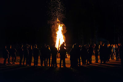 People standing against bonfire