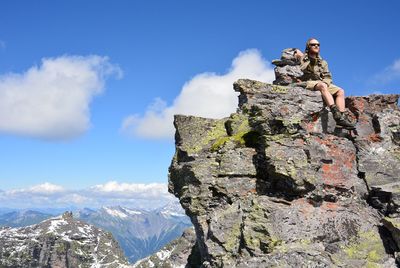 Low angle view of rocks on mountain against sky