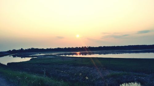 Scenic view of lake against sky during sunset