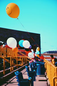 Multi colored balloons against sky