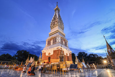 Low angle view of illuminated building against sky