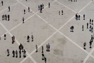 High angle view of people walking on road in city