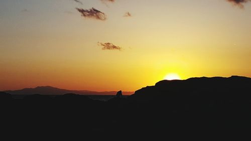 Scenic view of silhouette mountain against sky during sunset