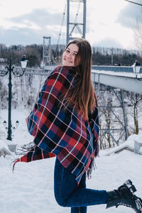 Woman standing on snow covered field