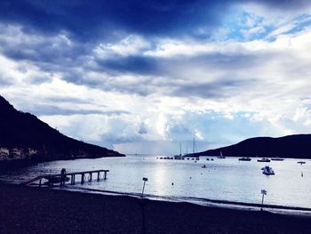 Scenic view of beach against cloudy sky