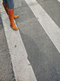 Low section of person standing on road