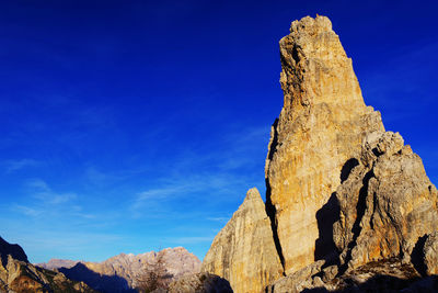 Low angle view of rock formation against blue sky