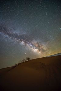 Scenic view of desert against sky at night
