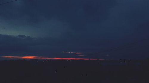 Silhouette landscape against sky at night