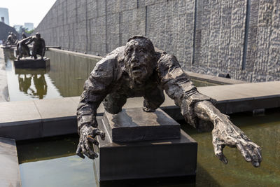 Statue against water