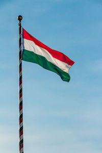 Low angle view of flags flag against sky