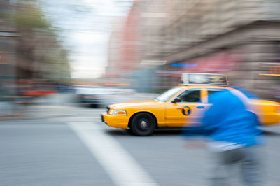 Blurred motion of man on city street