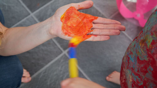 Close-up of hand holding multi colored working