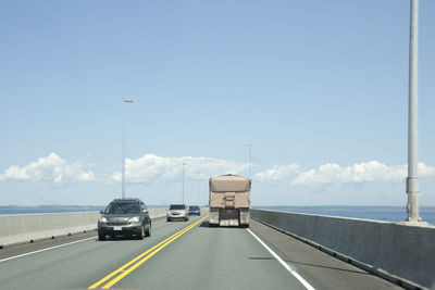 Cars on road against sky