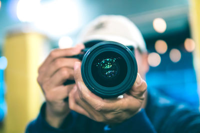 Close-up of man photographing with camera