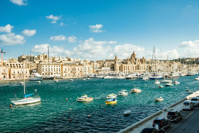 Sailing boats in harbor in front of historical scenery in malta