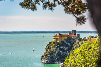 Gulf of trieste. high cliffs between boats, karst rocks and ancient castles. duino. italy