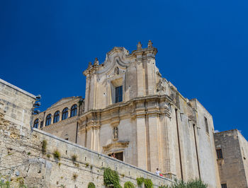 Low angle view of historic building against blue sky