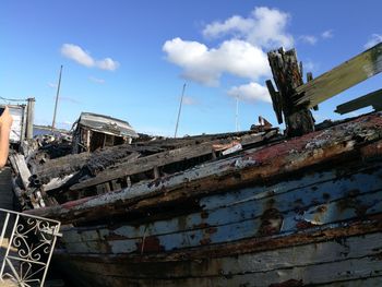 Low angle view of old abandoned building against sky