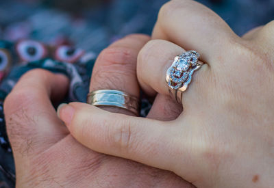 Cropped hands of couple wearing rings