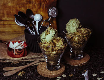 Glass of ice cream on table