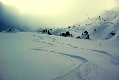 People enjoying in snow covered mountain