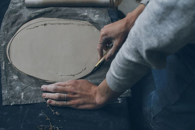 Close-up of person working with clay