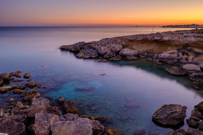 Scenic view of sea against sky at sunset