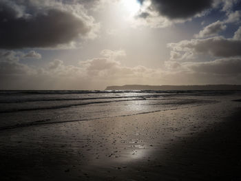 Scenic view of sea against cloudy sky